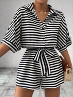 Striped button-up belted romper jumpsuit by Trendsi, featuring a casual design with vertical stripes and a comfortable fit.