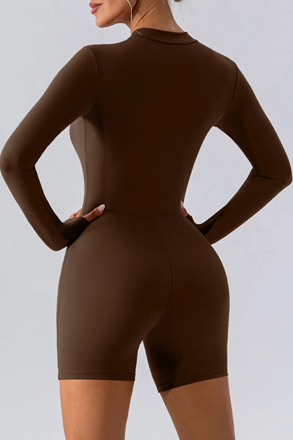 Trendsi half zip long sleeve active romper in breathable fabric, styled for athletic wear and casual workouts.