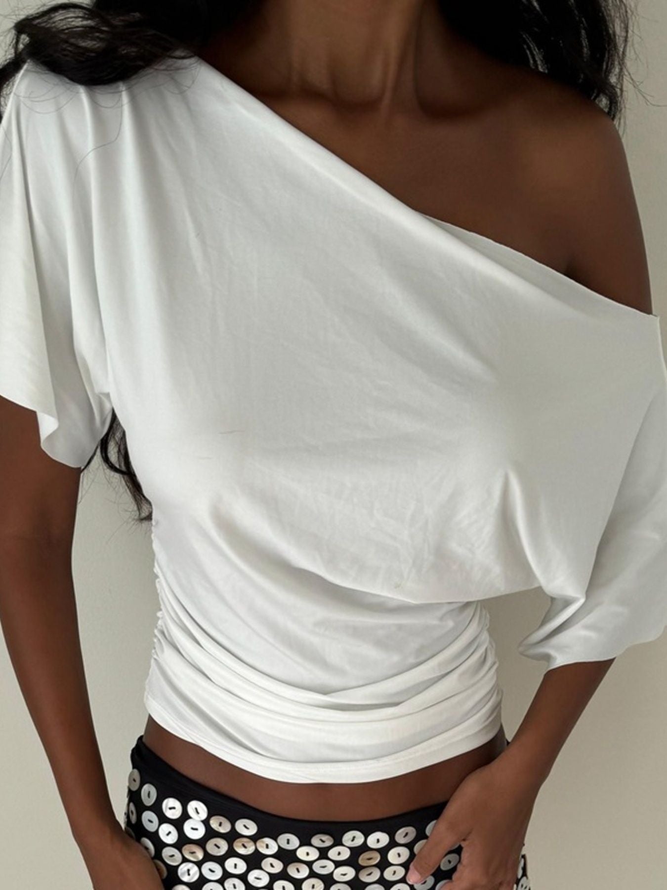 Women's one-shoulder ruched short sleeve T-shirt by Trendsi, featuring a chic stretch top with a stylish asymmetrical design.