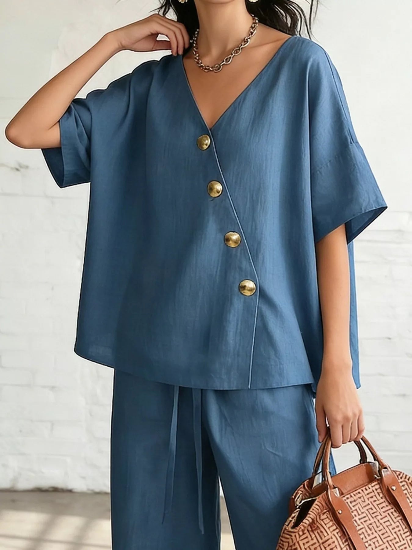 Plus size full surplice half sleeve top with wide-leg pants set by Trendsi, featuring stylish, comfortable fabric and modern design.