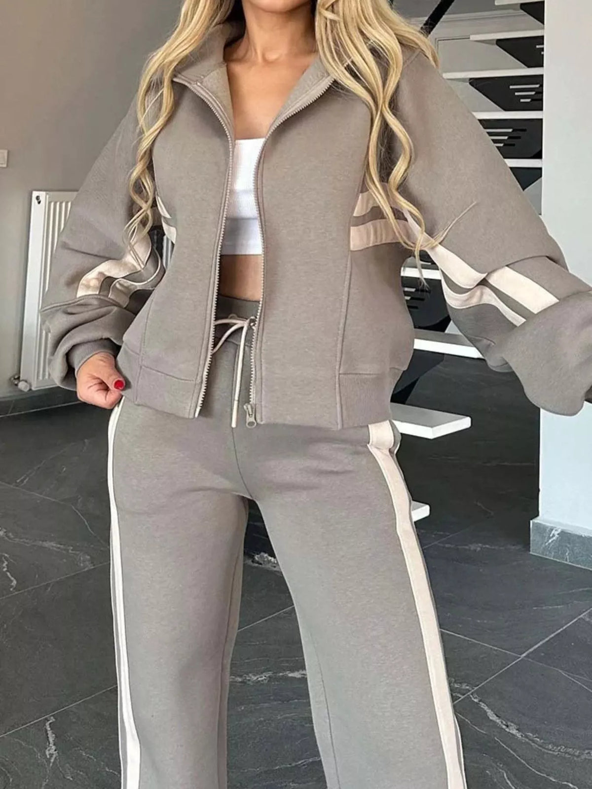 Plus size contrast stripe zip-up activewear jacket and pants set by Plush Fashion Hub, featuring bold stripe details and comfortable fit.