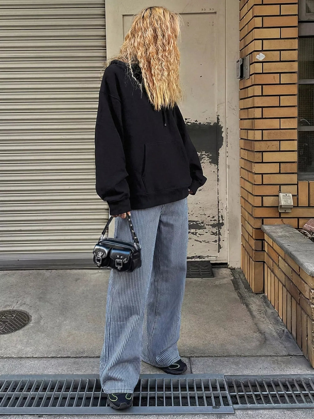 Striped wide-leg jeans by Shopimist featuring a high waist, relaxed fit, and bold vertical stripe pattern.