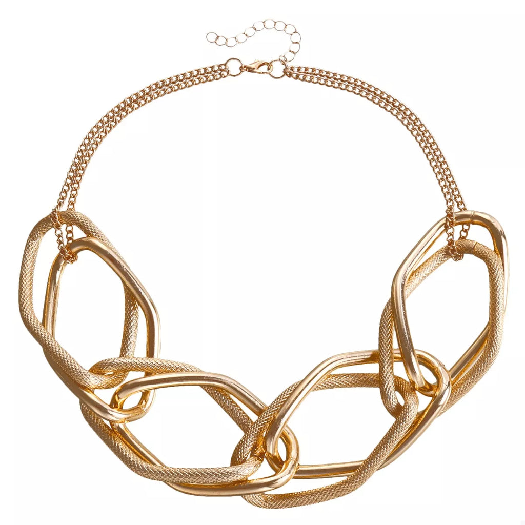 18K gold-plated chain necklace from Shopimist, close-up of the delicate, shiny jewelry with intricate link details.