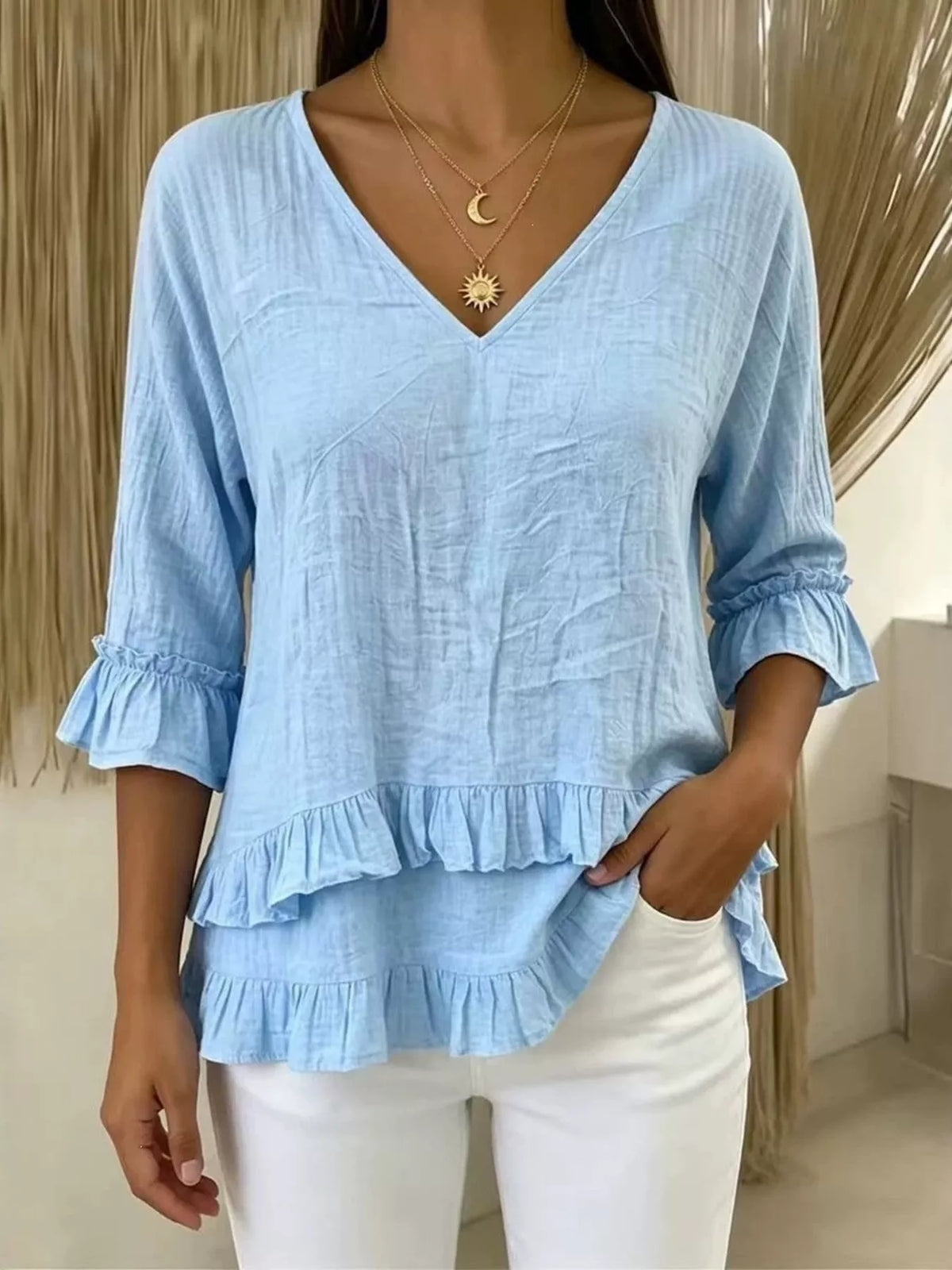 V-neck ruffle sleeve blouse by Trendsi, featuring a stylish design with soft fabric and feminine ruffle accents.