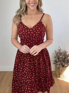 Floral print spaghetti strap midi dress with ruffle hem by Trendsi, featuring a flowy silhouette and vibrant floral pattern.
