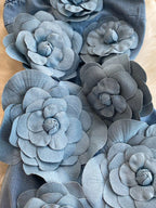Strapless denim dress with floral appliqué detail from Trendsi, showcasing a fitted bodice and stylish floral embellishments.
