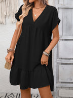 Women's casual V-neck mini dress by Trendsi featuring ruffle hem and ruched detailing, shown in a stylish, relaxed fit.