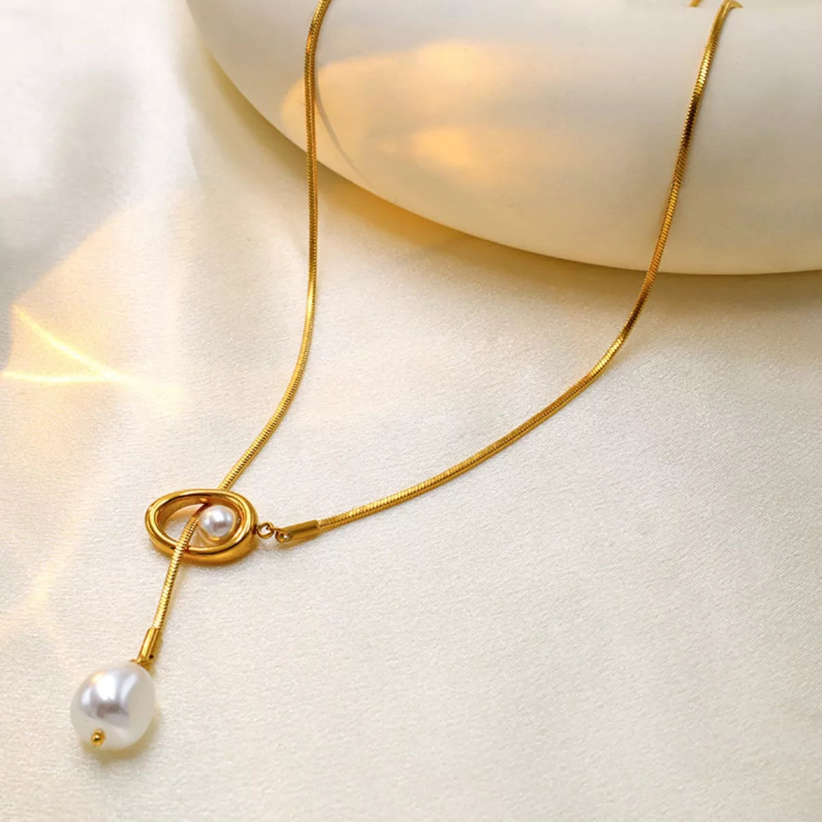 Elegant pearl pendant necklace by Shopimist featuring a single lustrous pearl on a delicate chain.