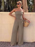 Smocked strapless wide-leg jumpsuit by Plush Fashion Hub, featuring a relaxed fit and stylish design in the image.