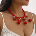 Cherry charm beaded statement necklace by Shopimist featuring vibrant red beads and a cherry pendant.