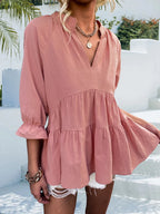Notched neck tiered cotton blend blouse with flounce sleeves, featuring a feminine design and trendy style.
