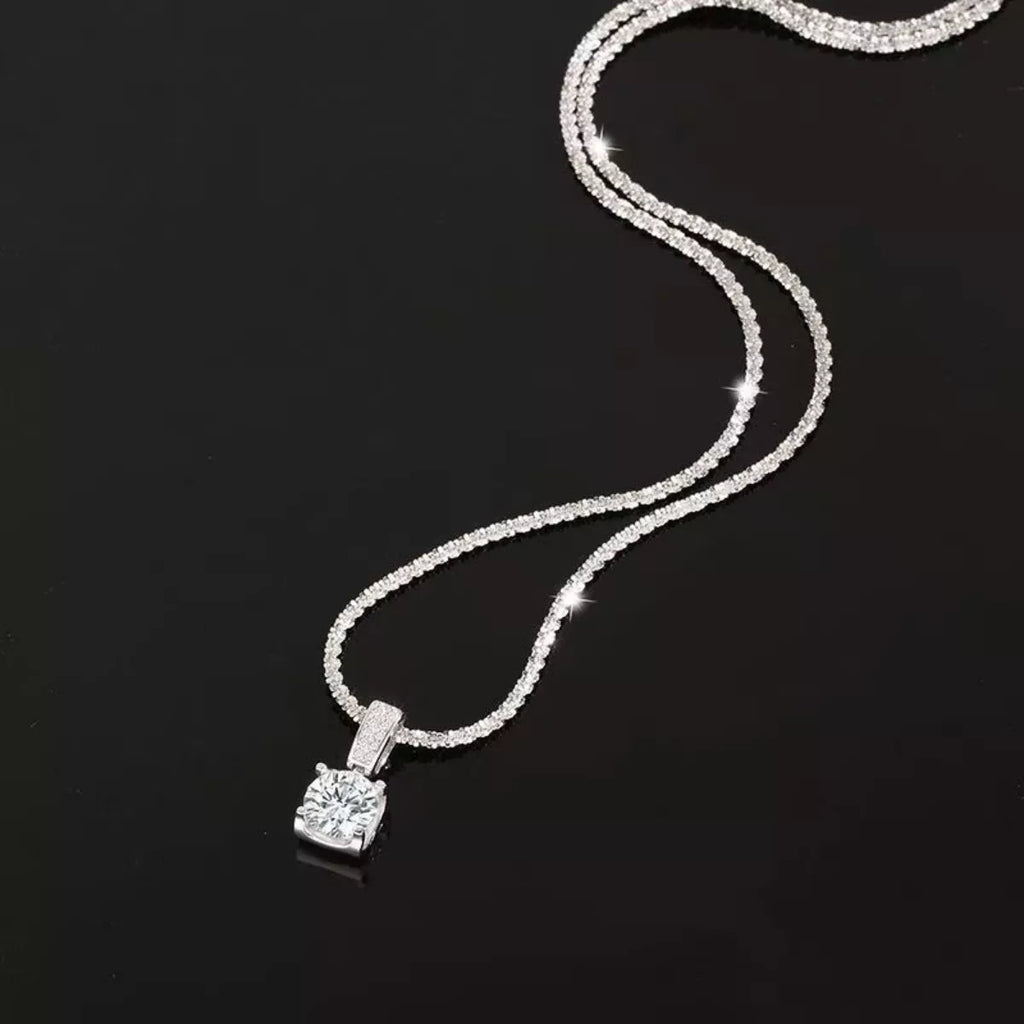 Sterling silver moissanite necklace with 1 carat center stone, elegant jewelry piece from Shopimist featuring sparkling gemstone.