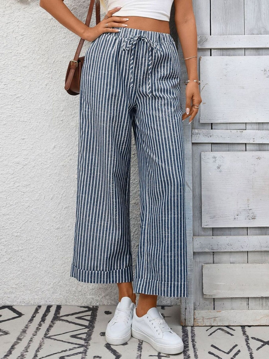 Women's striped wide-leg pants with drawstring waist and pockets, stylish Trendsi pants shown on model.