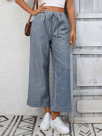 Women's striped wide-leg pants with drawstring waist and pockets, stylish Trendsi pants shown on model.