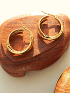 18K gold-plated titanium steel huggie earrings with sleek, minimalist design, featuring smooth, rounded hoops for modern style.