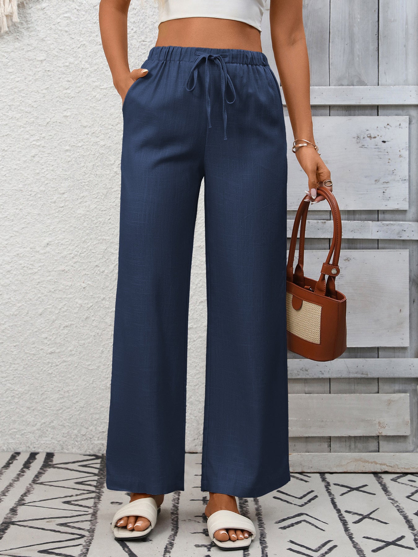 Women's high-waisted wide-leg drawstring pants in soft breathable viscose, stylish and comfortable for casual wear.
