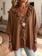 Plus size ruffle V-neck blouse with 3/4 sleeves by Trendsi, featuring a flowy fit and feminine ruffle details.