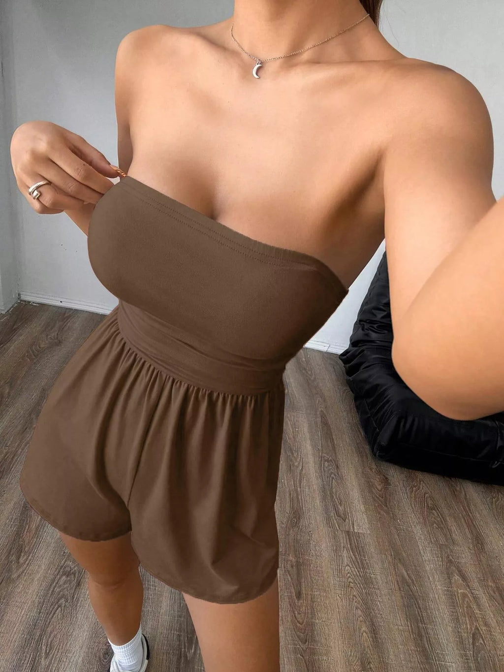 Chic strapless romper with ruched waist and trendy design, perfect for stylish summer or casual wear.