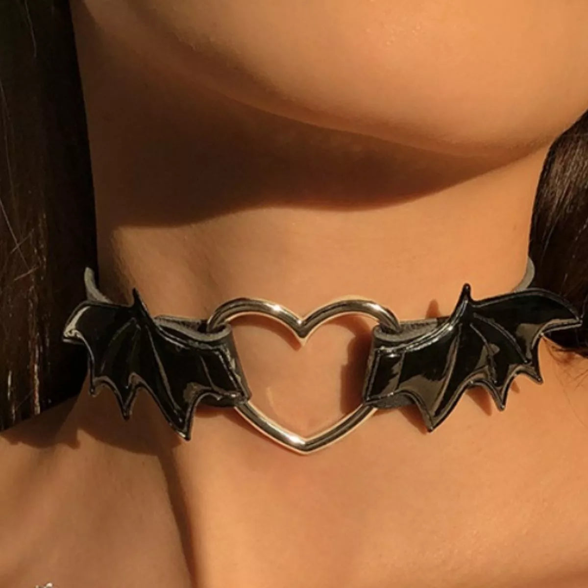 Gothic bat wing heart choker necklace with black fabric and metal bat and heart charms, ideal for gothic jewelry styles.