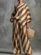 Plus size full set featuring a one-shoulder striped top and wide-leg pants from Plush Fashion Hub, stylish and comfortable outfit.