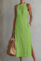 Women's sleeveless maxi dress with side slit and pockets by Plush Fashion Hub, featuring a flowing fabric and casual style.
