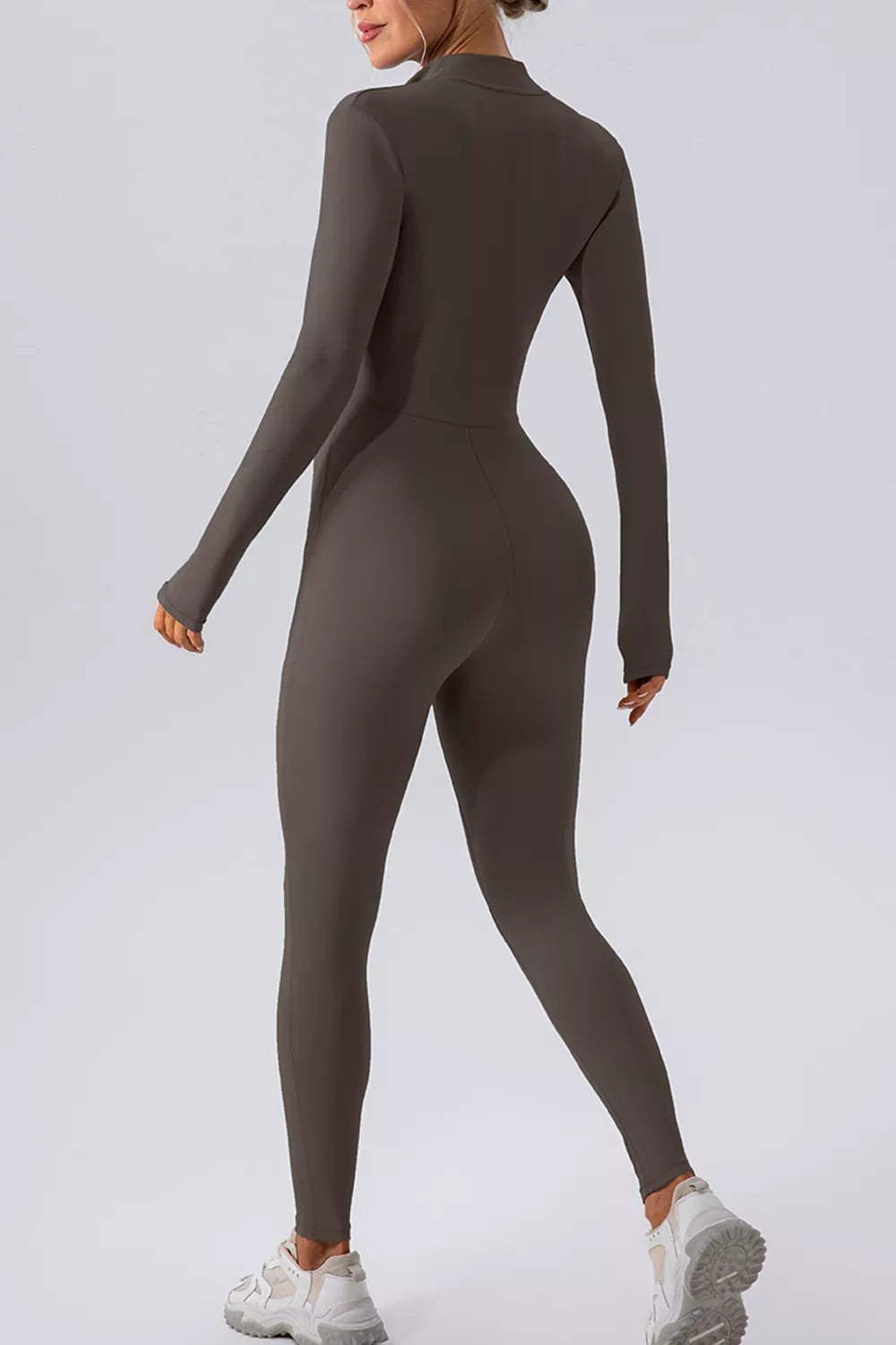 Trendsi half zip mock neck active jumpsuit showing a sleek, fitted design with a high neckline and full-length legs.