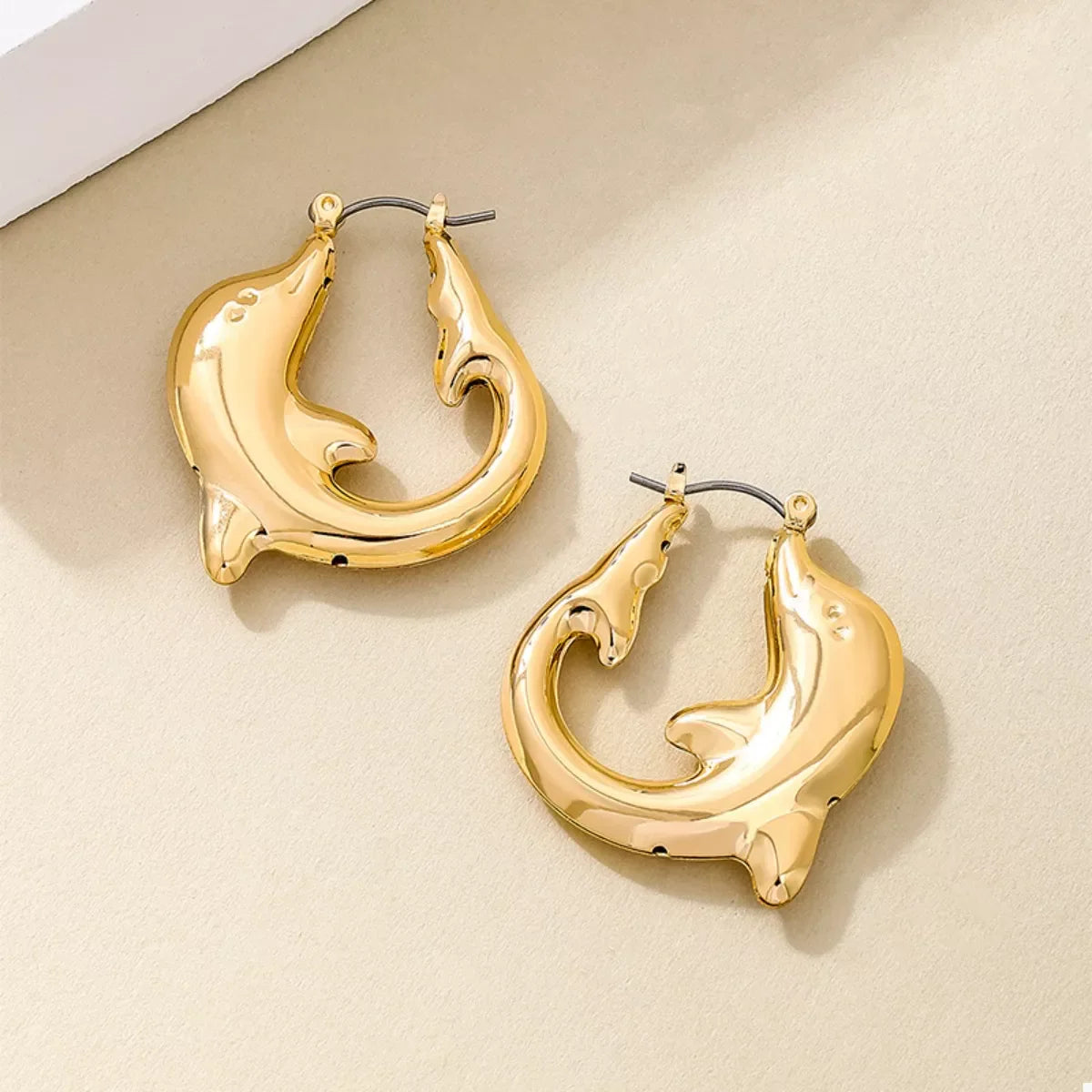 18K gold-plated dolphin hoop earrings with a shiny finish, featuring detailed dolphin designs for a stylish and elegant look.