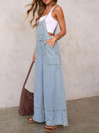 Women’s relaxed fit wide-leg denim overalls jumpsuit made from comfortable cotton blend, displayed on a hanger.