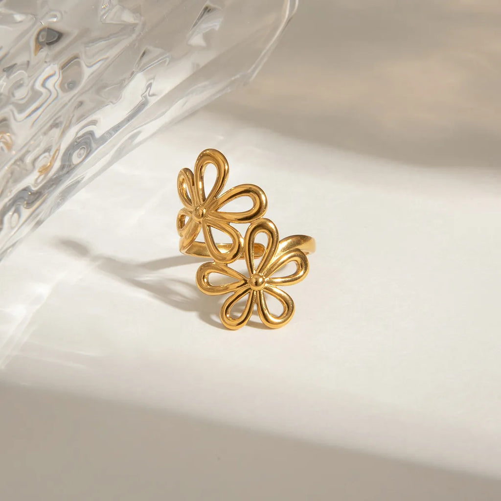 Stainless steel flower ring with intricate floral design, shiny finish, and adjustable band, crafted by Shopimist.