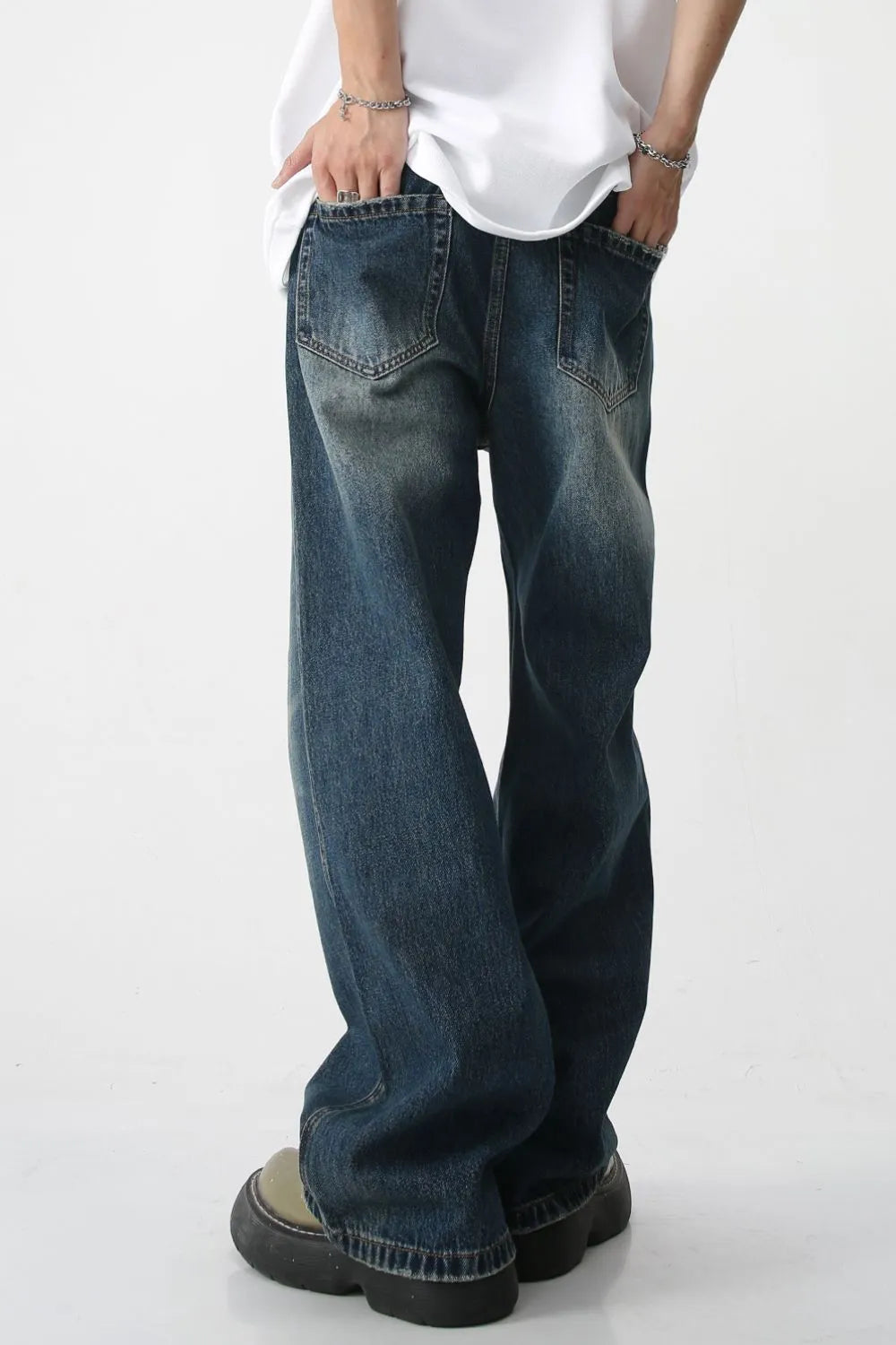 Plush Fashion Shop denim bootcut jeans with front and back pockets, classic blue wash, relaxed fit, and stylish silhouette.