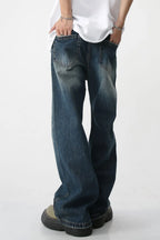 Plush Fashion Shop denim bootcut jeans with front and back pockets, classic blue wash, relaxed fit, and stylish silhouette.