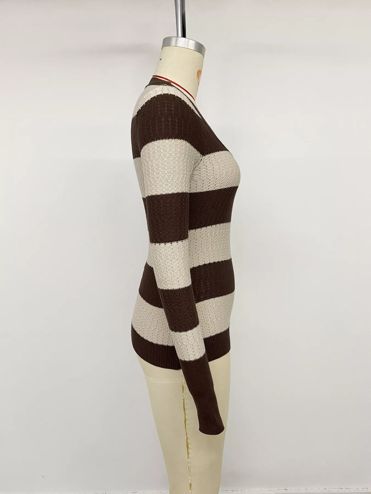Striped V-neck knit top by Plush Fashion Hub featuring a classic pattern and soft fabric for a stylish, comfortable look.