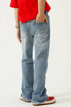 Raw hem denim jeans with pockets from Trendsi, showcasing a casual fit and distressed raw hem style in a natural pose.