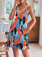 Tropical leaf print V-neck sleeveless dress from Shopimist, featuring vibrant green foliage on lightweight fabric.