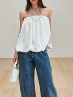 Women's strapless bubble hem tube top by Plush Fashion Hub, sleek and trendy minimalist crop top with a fitted silhouette.
