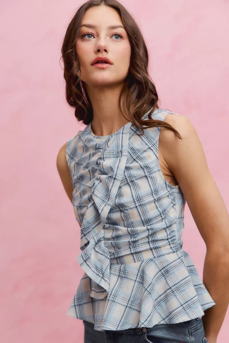 Plaid sleeveless ruffle peplum top by Plush Fashion Hub featuring a feminine design and stylish peplum detail.