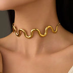 18K gold-plated wave necklace with flowing ocean-inspired design, crafted by Shopimist, displayed on a neutral background.