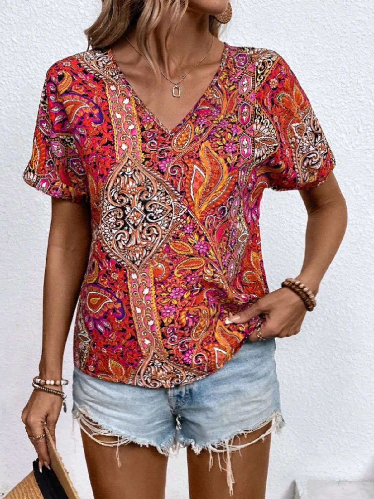 Bohemian paisley V-neck short sleeve T-shirt by Plush Fashion Hub featuring colorful paisley pattern and relaxed fit.