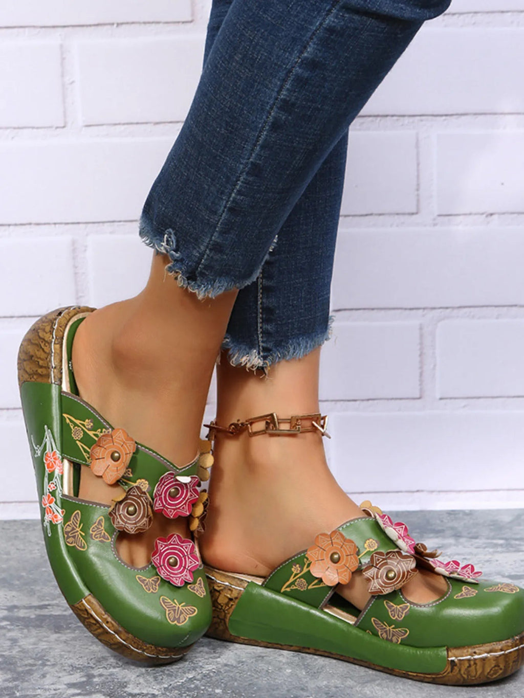 Floral round-neck flat sandals in premium PU leather featuring a summer floral design and comfortable slip-on style.