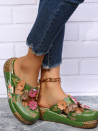 Floral round-neck flat sandals in premium PU leather featuring a summer floral design and comfortable slip-on style.