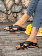 Women's floral comfort wedge sandals with low heel, stylish PU leather shoes featuring a floral design and adjustable straps.