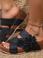 Women's floral crisscross wedge sandals with comfortable mid-heel design, perfect for summer wear.