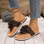 Women's floral toe post flat sandals in premium faux leather with colorful flower accents, trendy and comfortable footwear.
