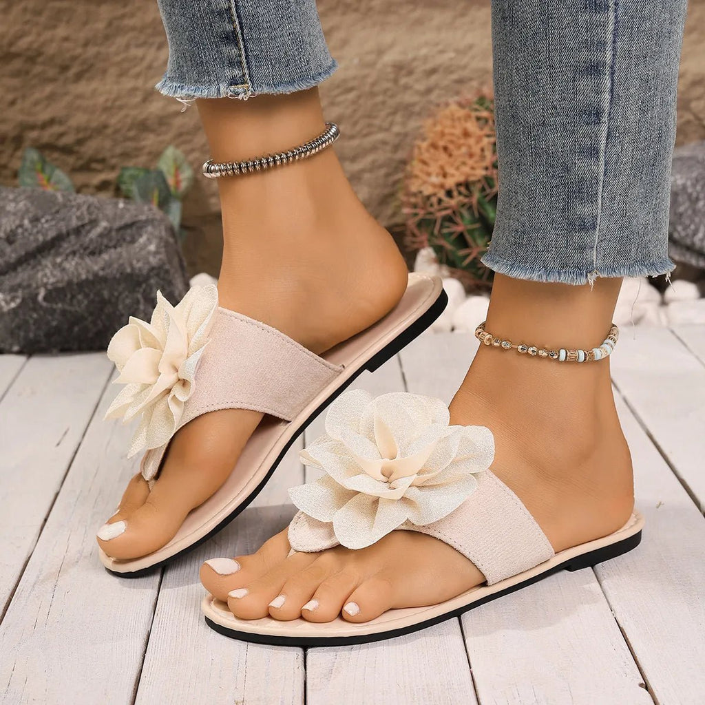 Women's floral toe post flat sandals in premium faux leather with colorful flower accents, stylish and comfortable footwear by Trendsi.