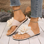 Women's floral toe post flat sandals in premium faux leather with colorful flower accents, stylish and comfortable footwear by Trendsi.