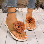 Women's floral toe post flat sandals made of premium faux leather, featuring colorful flower designs and comfortable slip-on style.