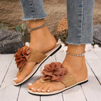 Women's floral toe post flat sandals in premium faux leather with colorful flower design, casual summer footwear by Trendsi.