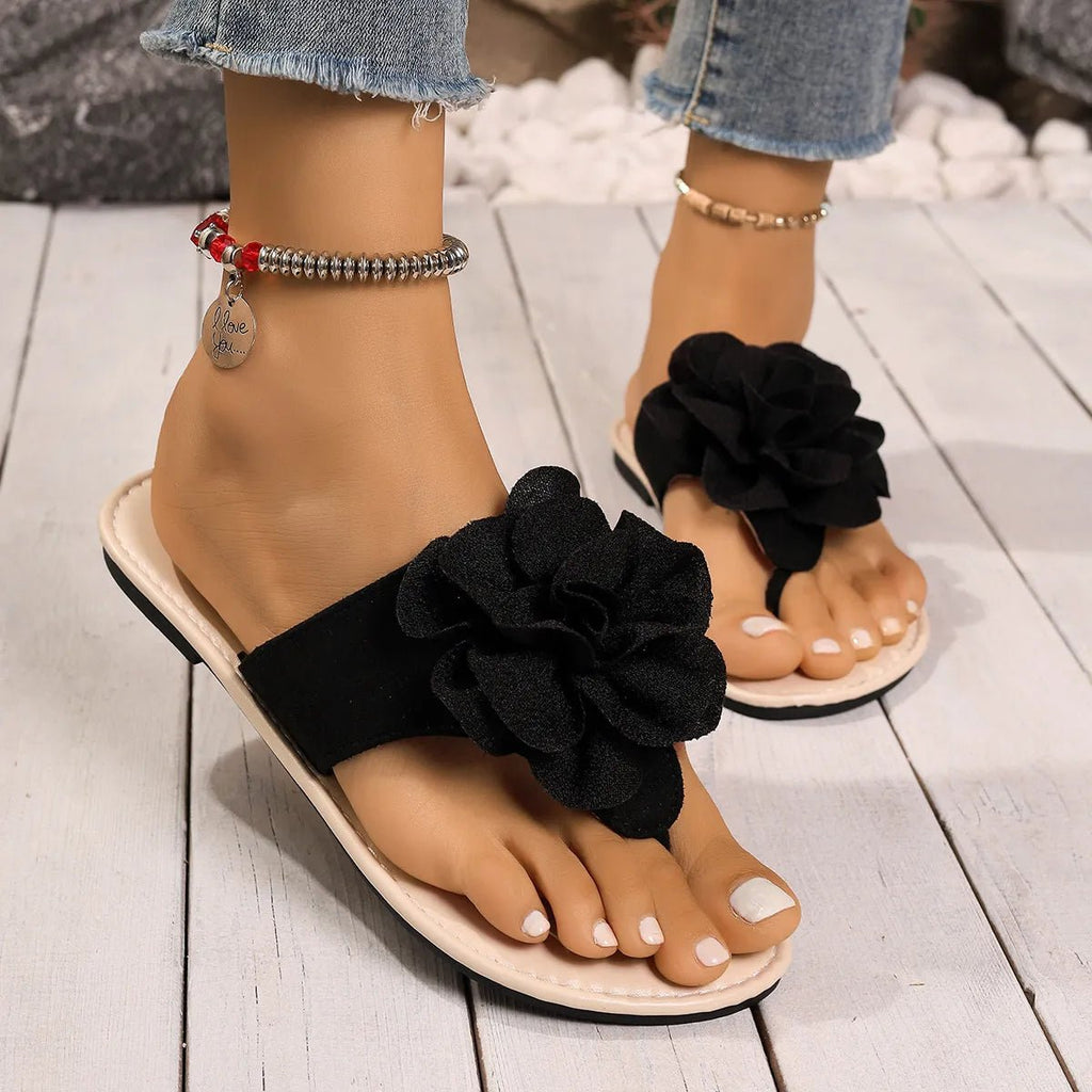 Women's floral toe post flat sandals in premium faux leather with colorful flower accents, casual summer footwear by Trendsi.