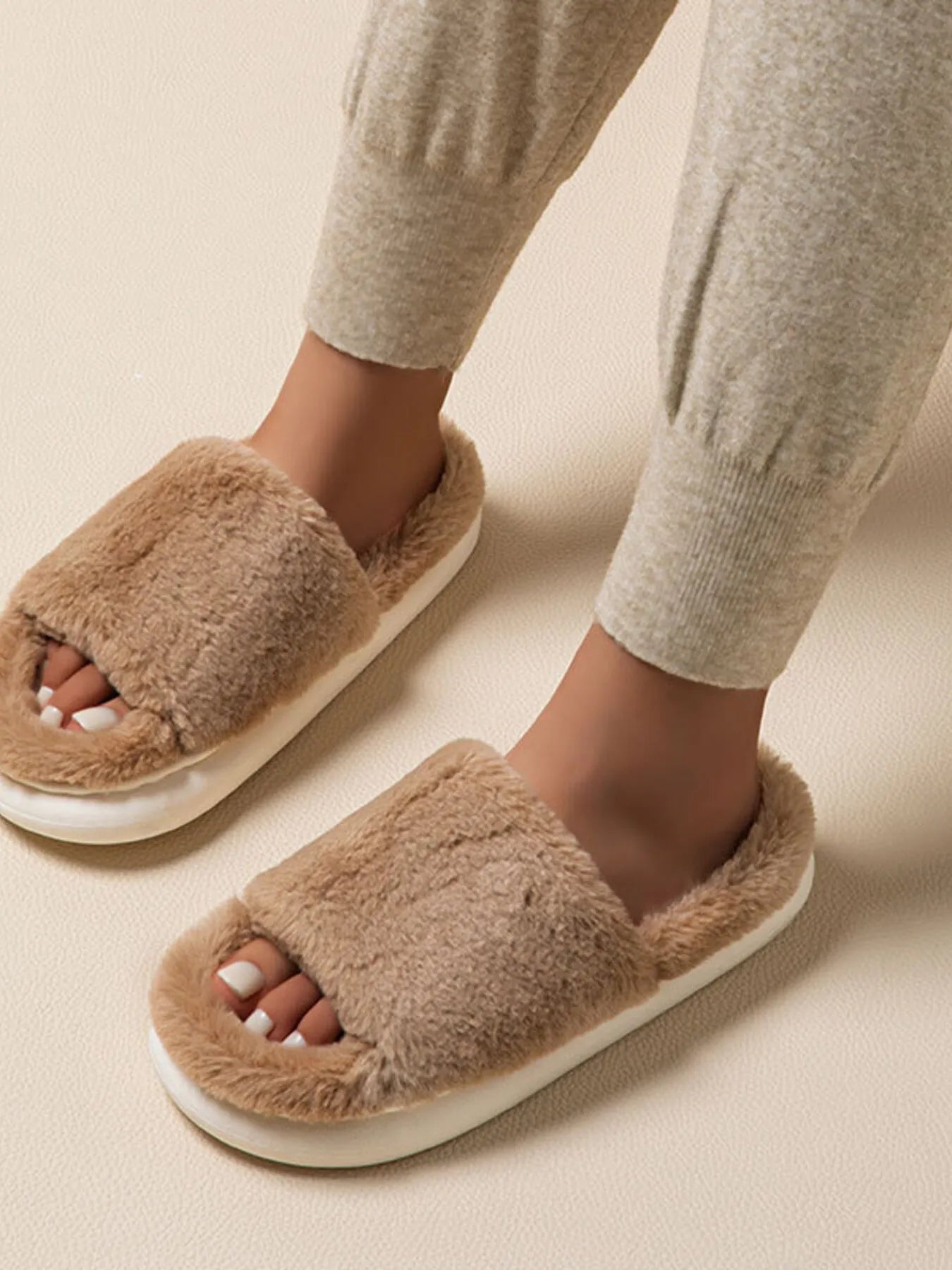 Fluffy open-toe faux fur slippers for women, soft indoor house shoes with plush comfort, from Trendsi.