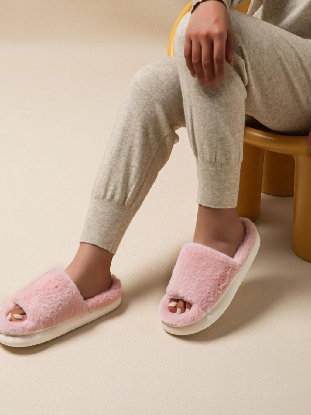 Fluffy open-toe faux fur slippers for women, soft indoor house shoes with plush comfort and cozy design.